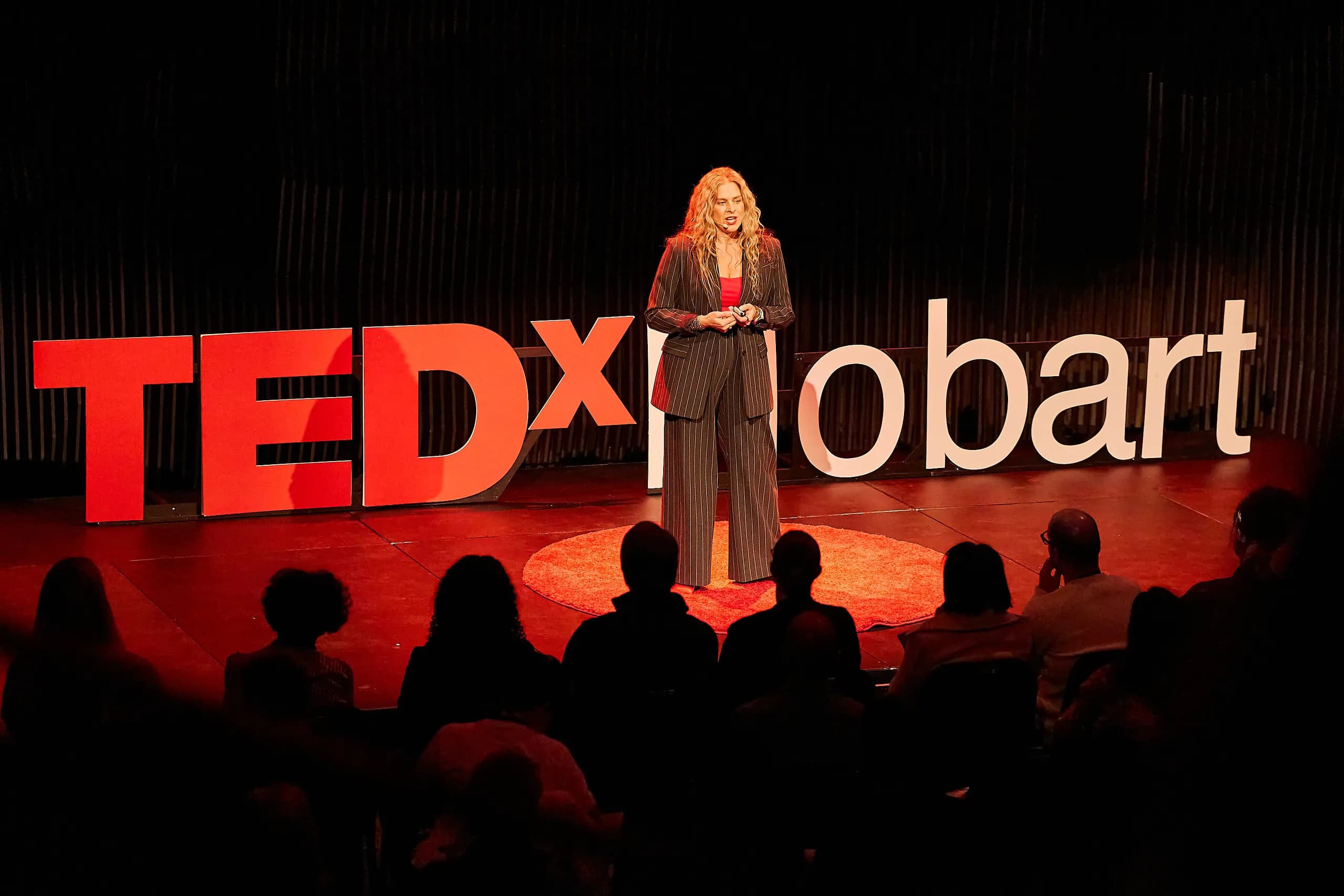 Dr Rebecca Chabot delivering her TEDx Hobart talk on stage