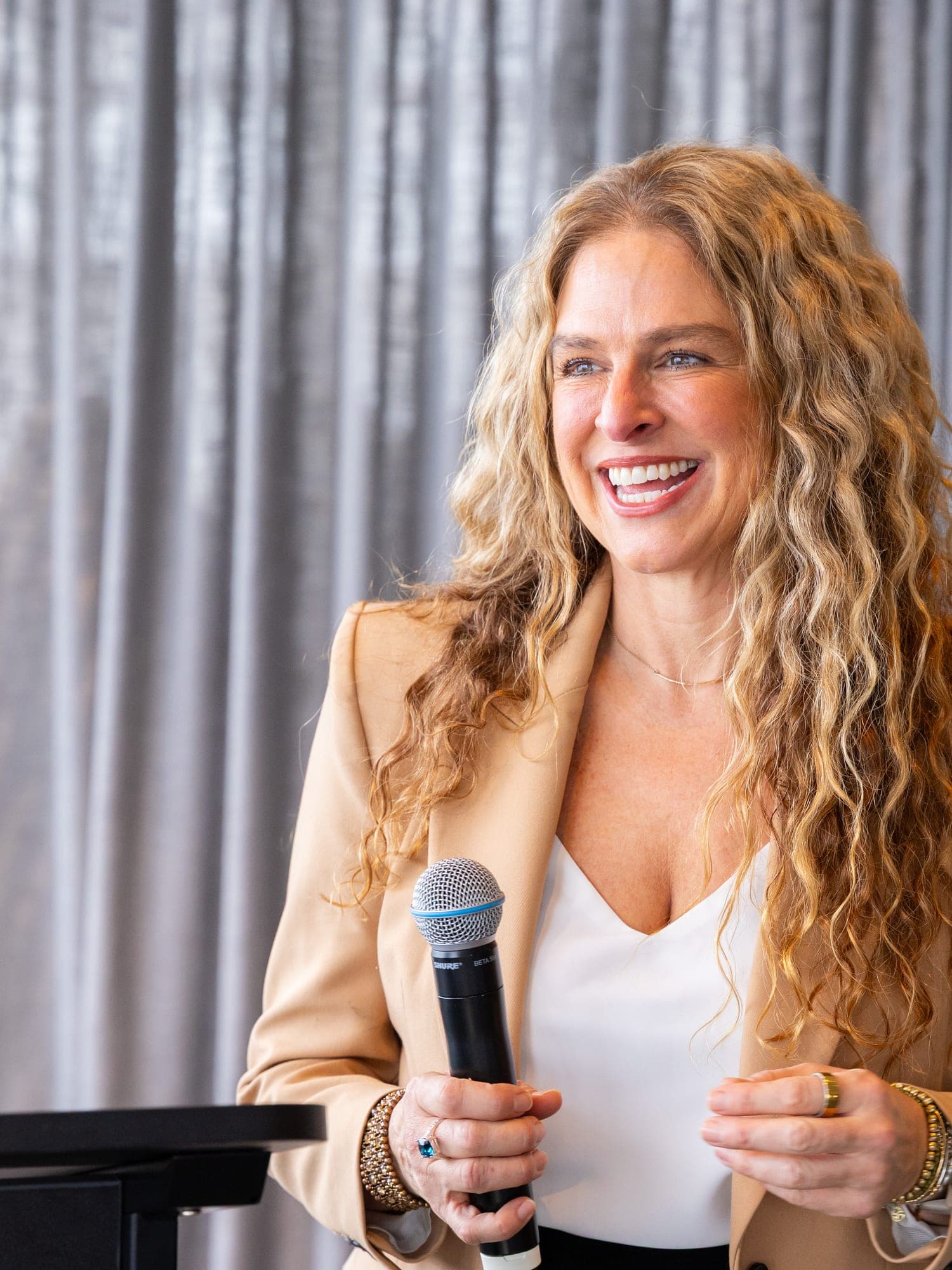 Dr Rebecca Chabot speaking with a microphone at a lectern