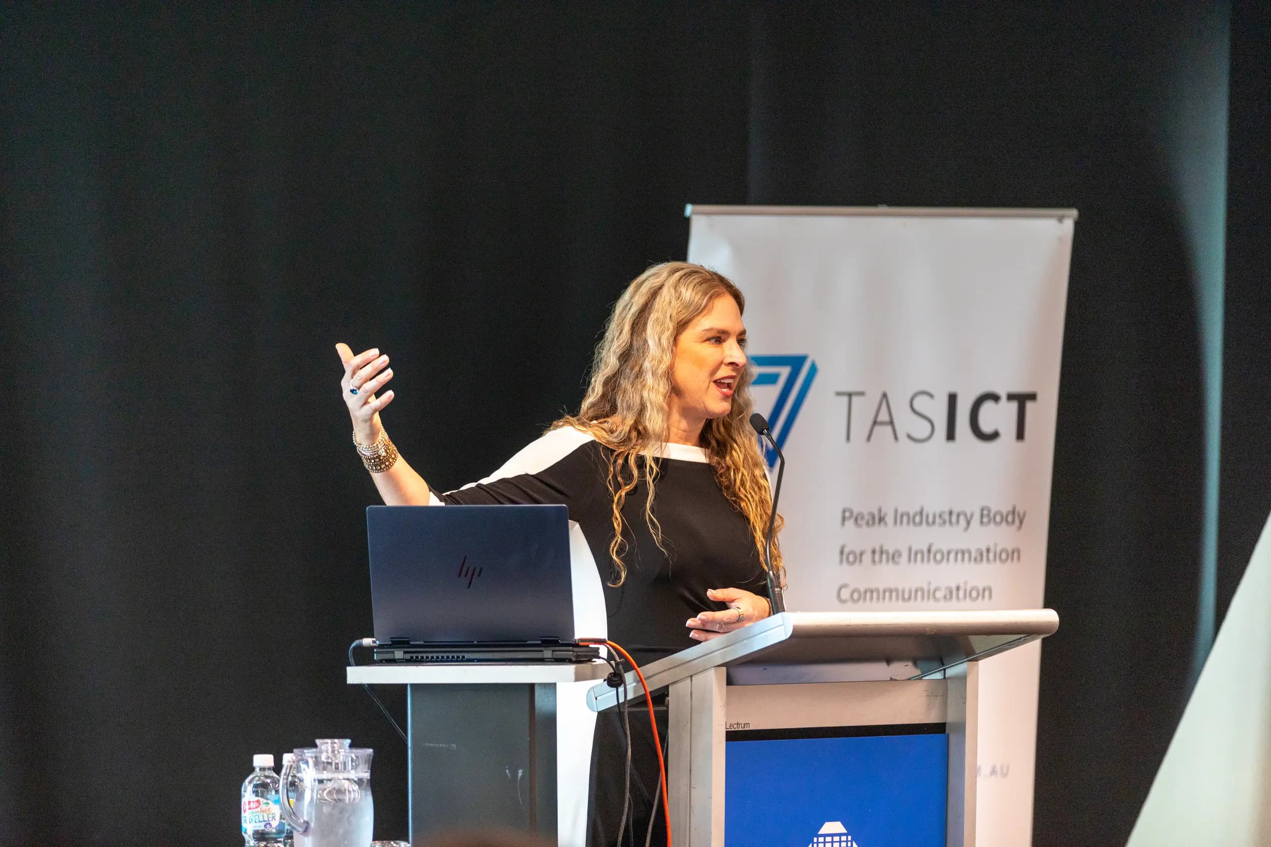Dr Rebecca Chabot speaking at the lectern at a TasICT conference