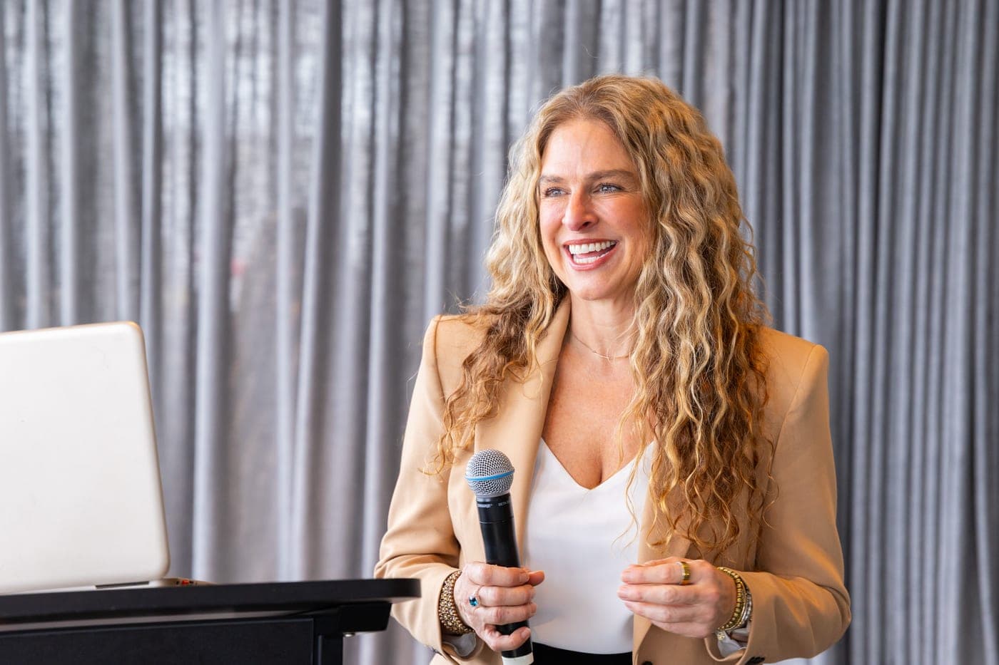 Dr Rebecca Chabot speaking with a microphone at a lectern
